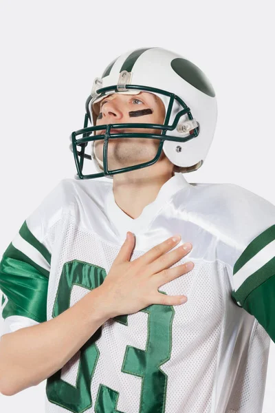 Young Man Football Uniform Hand Chest Gray Background — Stock Photo, Image