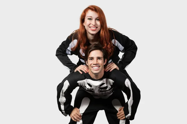 Portrait Young Man Giving Piggyback Ride Skeleton Costume Gray Background — Stock Photo, Image