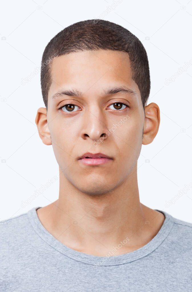 Portrait of young mixed race man against white background