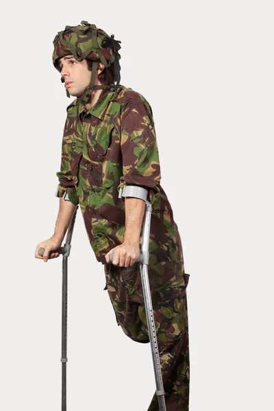 Young Soldier Holding Crutches Gray Background — Stock Photo, Image