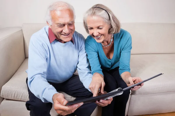 Happy Senior Couple Looking Spiral Book — Stock Photo, Image