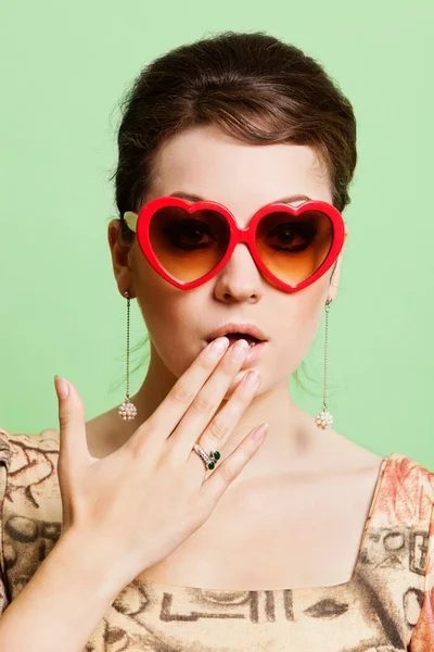 Portrait Shocked Young Woman Wearing Heart Shaped Sunglasses Green Background — Stock Photo, Image