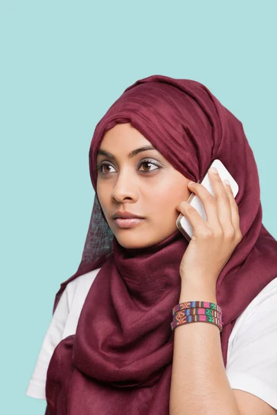 Young Muslim Woman Maroon Headcloth Using Cell Phone Blue Background — Stock Photo, Image