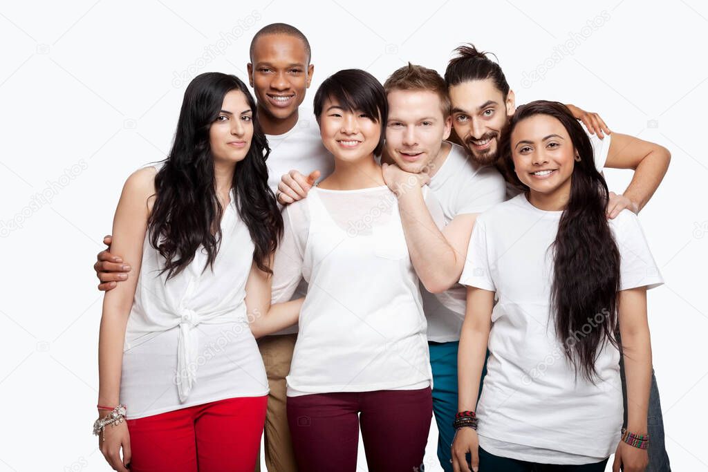 Portrait of young multi-ethnic friends in casuals smiling over white background