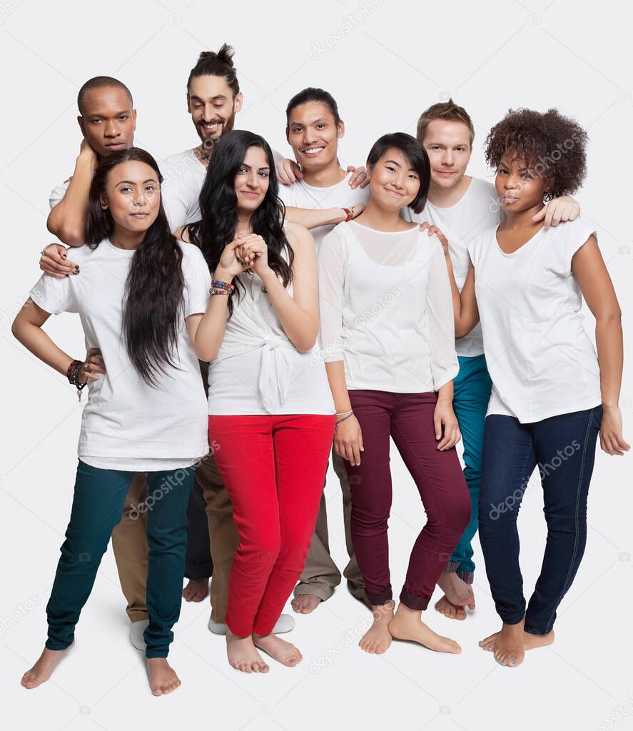 Portrait of young multi-ethnic friends posing together against white background