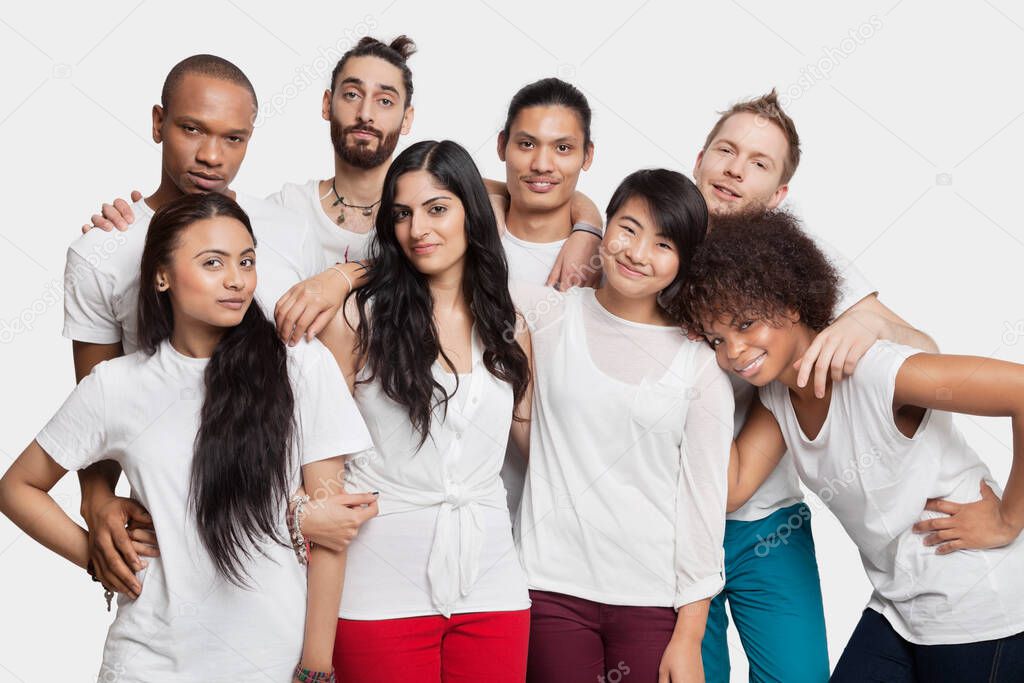 Portrait of young multi-ethnic friends posing against white background