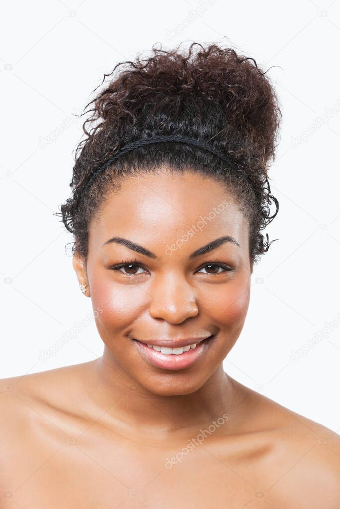 Beauty portrait of smiling young African American woman over white background
