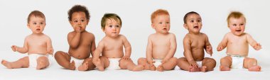 Row of six multi ethnic Babies smiling in studio clipart