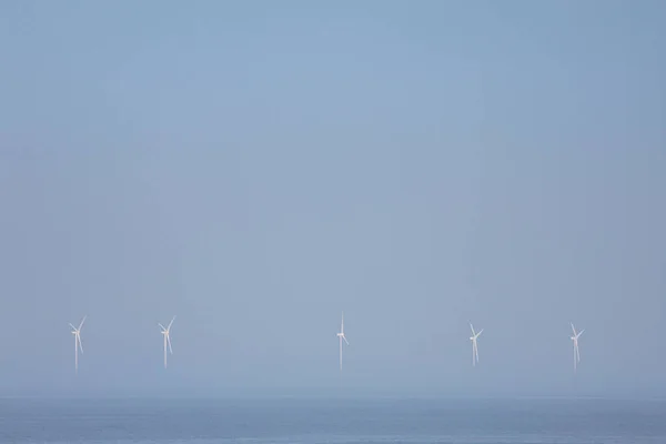 Wind farm in ocean on background
