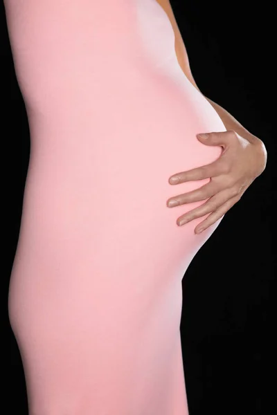 身穿紧身衣的孕妇抱着腹部 — 图库照片