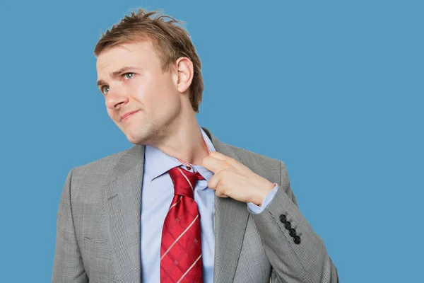 Tired Young Businessman Loosening Tie — Stock Photo, Image