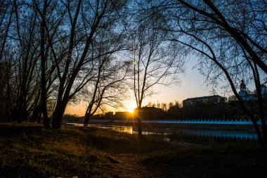 yellow, warm sunset on the banks of the Urals, and on the other side of the embankment of the city of Orenburg