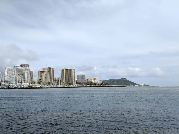 Skyline of Waikiki and Diamond Head during day with yachts and boats in Ala Moana harbor, Hotels, Crane, and Hilton Hawaiian Village framing Diamond Head in Waikiki, Oahu, Hawaii.  2018