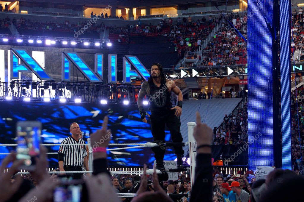 Santa Clara - March 29, 2015: Roman Reigns wrestler stands on top turnbuckle before start of championship matchh at Wrestlemania 31 at the Levi's Stadium in Santa Clara, California on March 29, 2015.