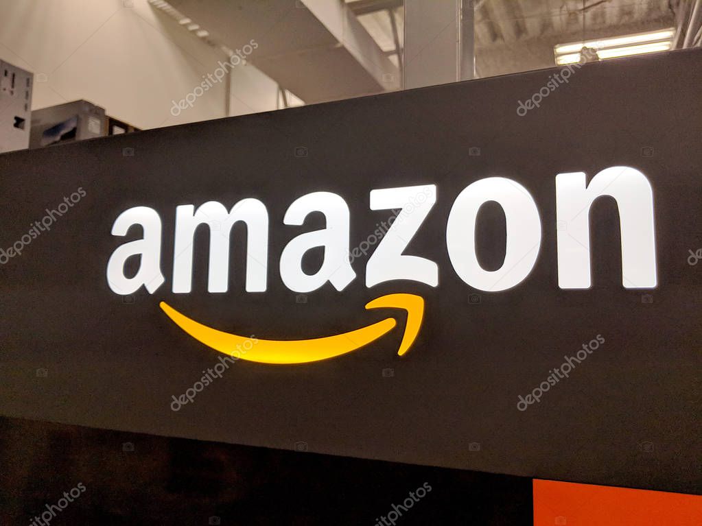 Fox Hills, Culver City, California -  October 25, 2018:    Amazon logo on black shiny wall in California Best Buy store.  Amazon is an American international electronic commerce company. It is the world's largest online retailer.