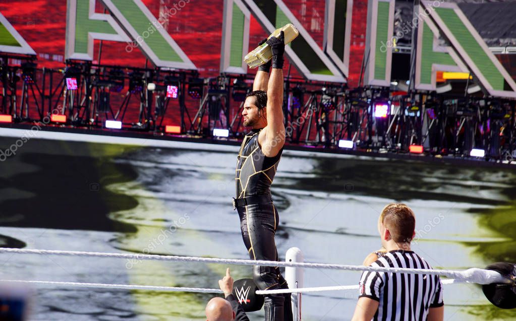 SANTA CLARA - MARCH 29: WWE Wrestler Seth Rollins holds up Money in the Bank Briefcase top of the ropes before match in the ring at Wrestlemania 31 at the Levi's Stadium in Santa Clara, California on March 29, 2015.