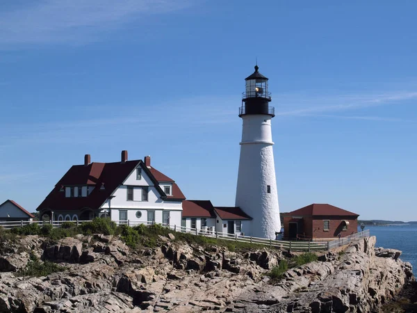 Portland Head Lighthouse and Keepers\' Quarters building in Portland, Maine.  Portland Head Light, is a historic lighthouse in Cape Elizabeth, Maine. The light station sits on a head of land at the entrance of the primary shipping channel into Portlan