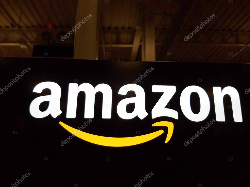 Honolulu - January 12, 2017:  Amazon logo on black shiny wall in Honolulu Best Buy store on January 12, 2017.  Amazon is an American international electronic commerce company. It is the world's largest online retailer.