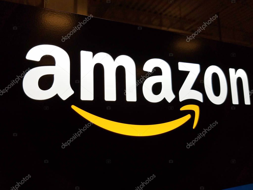 Honolulu - January 12, 2017:  Amazon logo on black shiny wall in Honolulu Best Buy store on January 12, 2017.  Amazon is an American international electronic commerce company. It is the world's largest online retailer.