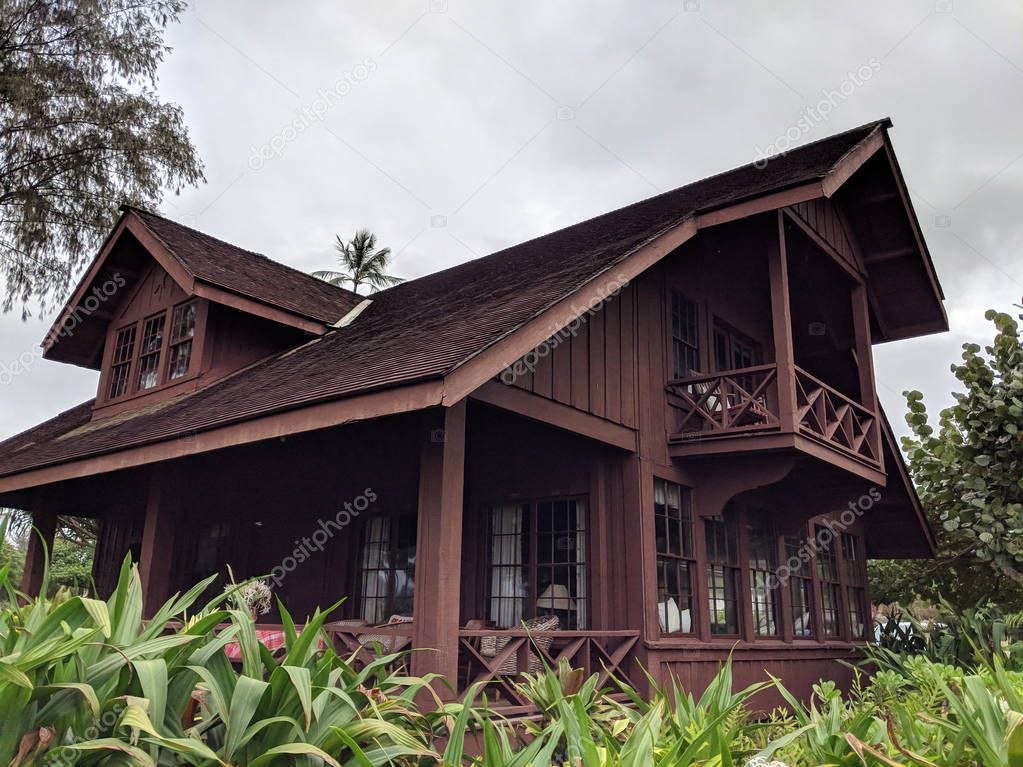 Mabel Wilcox Hanalei Beach House.  This beach house is a one-and-a-half story, wood-frame L shaped house with board-and-batten walls, high-pitched gable roof, overhanging eaves, a deep lanai that faces Hanalei Bay, and interior Craftsman design.