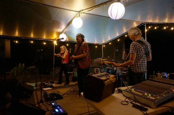 Rock band Roxotica playing under covered light stage — Stock Photo, Image