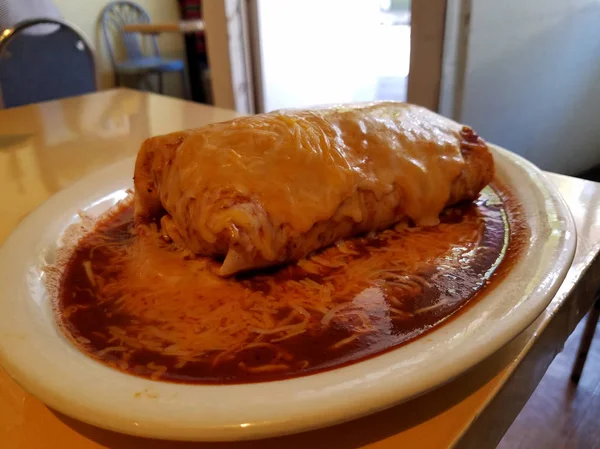 Burrito molhado com molho vermelho e queijo em cima — Fotografia de Stock