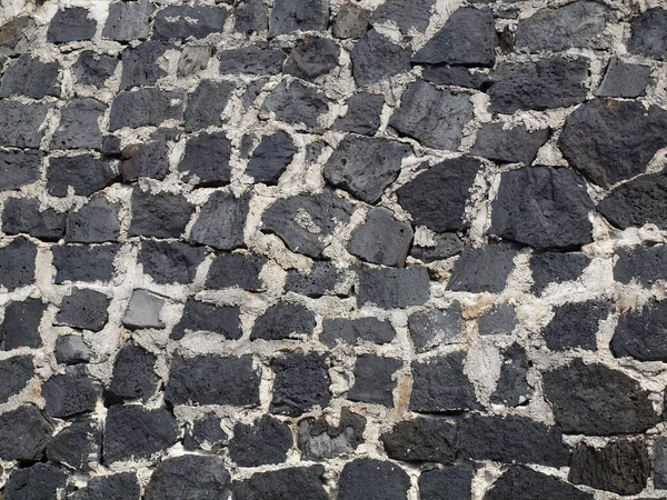 Close-up de uma antiga parede de pedra de lava cimentada — Fotografia de Stock