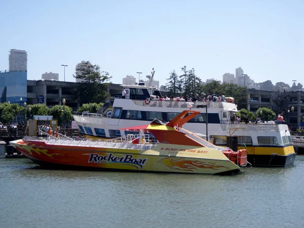 Les gens à bord Ferry Boat avec bateau de vitesse le RocketBoat en face — Photo