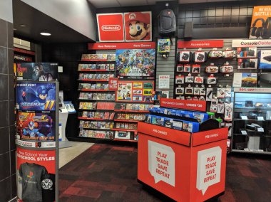 Nintendo Switch and other video game merchandise on display at G clipart