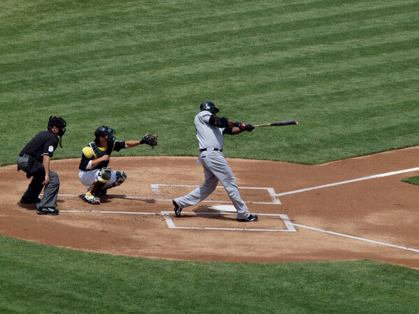 Oakland, California - July 21, 2010: Red Sox vs. Athletics: Red Sox David Ortiz makes contact with pitch with Kurt Suzuki Catching.