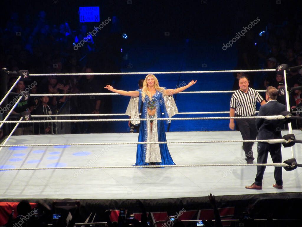 Honolulu - September 22, 2019: Wrestler Charlotte Flair stands in the ring with arms in the air at WWE event at the Neal S. Blaisdell Center, Honolulu.