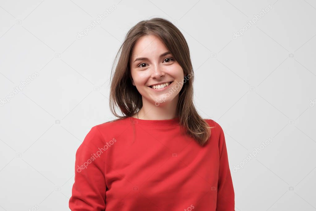 Portrait of young beautiful gcaucasian woman in red t-shirt cheerfuly smiling looking at camera.