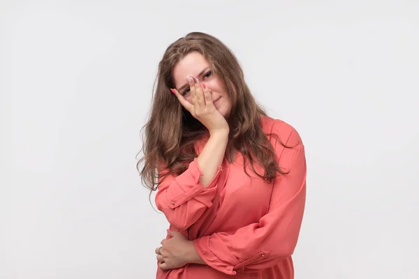 Closeup of depressed european woman in red shirt. She is looking down. — Stock Photo, Image