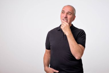 Olgun İspanyol adam ile düşünme uzakta çene seyir eller. Gerçek insanlar portresi kapatın.