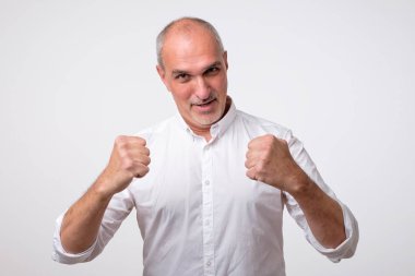 Kazanan, portre portre mutlu başarılı İspanyol adam yumruk pompalanan kutluyor başarı izole gri duvar arka plan.