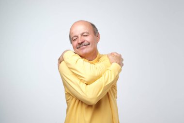 Kendini sarılma portre portre emin gülümseyen adam. En iyi kavramı ben. Yumuşak giysilerinle yıkama sonrası