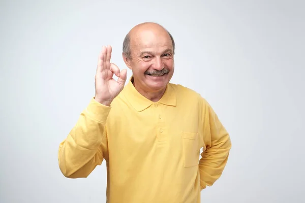 Handsome Mature Man Yellow Tshirt Showing Sign Looking Camera Smiling — Stock Photo, Image