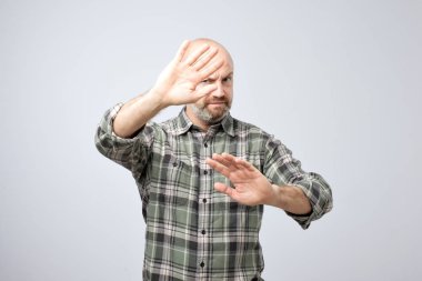 Olgun adam fikrini kabul reddederek eller fotoğraf gri arka plan üzerinde uzanan sıktı. Bu kavram gerekmez. Benden uzak gitmek.