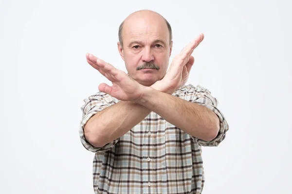 Senior bald man with mustache making stop sign with hand. I do not give you a permission. — Stock Photo, Image