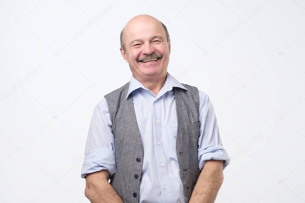 Confident hispanic mature man laughing and smiling