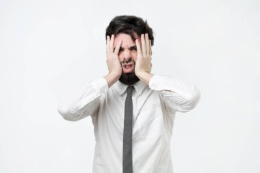 Olgun İspanyol adam eliyle yüzünde cilt çekerek rahatsız. O korkmuş ya da stres yorgun.