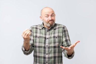Basit olmak birisi, çatık ve clueless ifade ile gri duvardan ekşitmeden sorguladı bir şeyler açıklamaya Avrupa adam Olgun