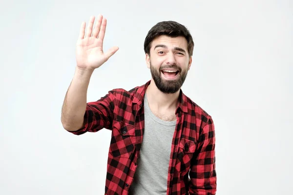 Amichevole cercando educato giovane uomo ispanico vestito con camicia a scacchi dire ciao — Foto Stock