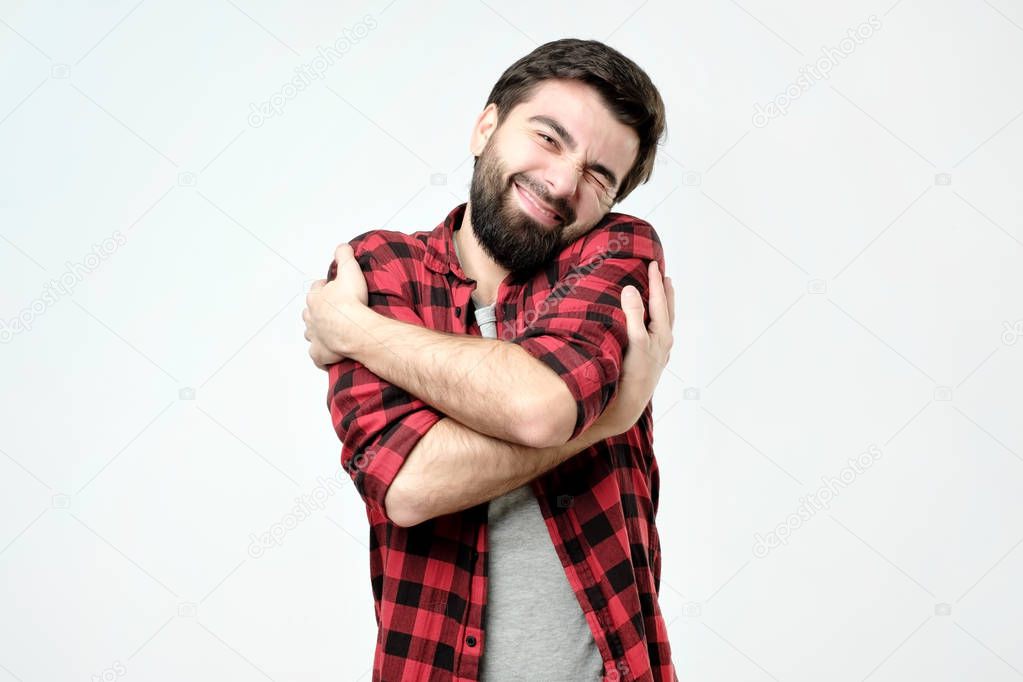 portrait confident smiling man hugging himself. I am the best concept.