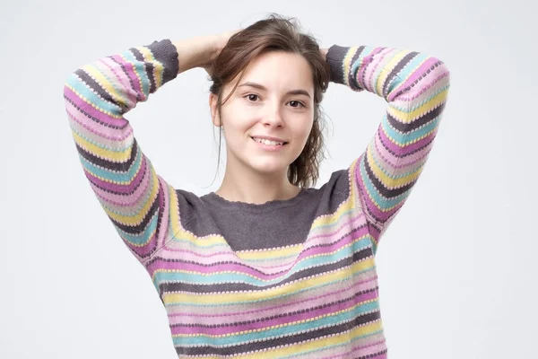 Beautiful young smiling woman in multi colored sweater — Stock Photo, Image