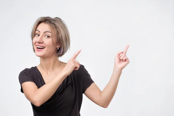 Nice cute charming attractive cheerful girl pointing aside up — Stock Photo, Image