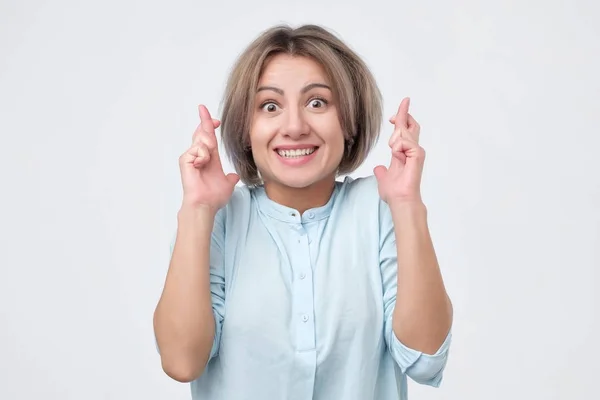 Girl keeping fingers crossed, hoping for good luck or winning lottery. — Stock Photo, Image