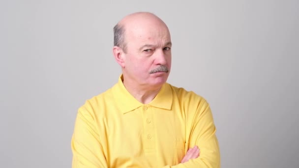 Senior bald man showing refusal gesture, shaking his head — Stock Video