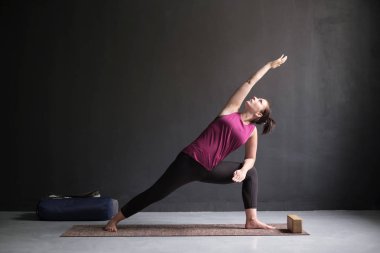 Genişletilmiş yan açı duruş, yapıyor kadın Utthita Parsva Konasana.
