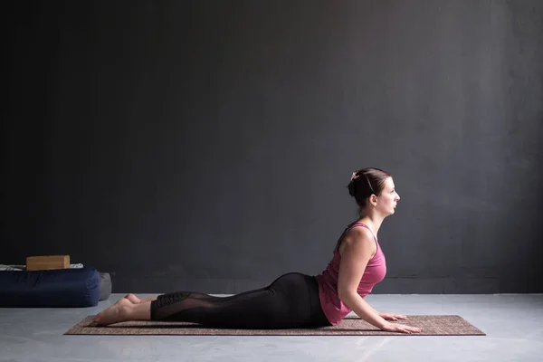 Beautiful sporty fit yogini woman practices yoga asana bhujangasana — Stock Photo, Image